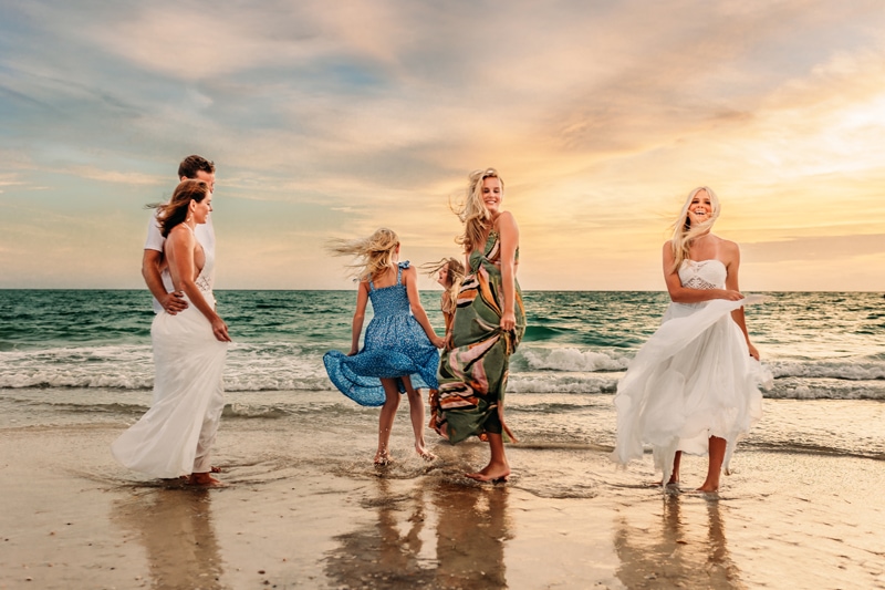 Family photography, siesta key, family photographer, a family o six dancing and hugging at the edge of the water